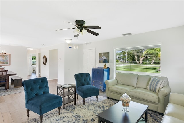 living room with ceiling fan and light wood-type flooring