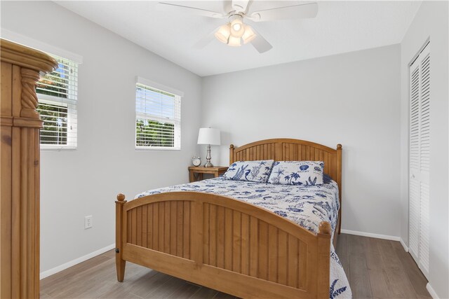 bedroom featuring a closet, hardwood / wood-style floors, and ceiling fan