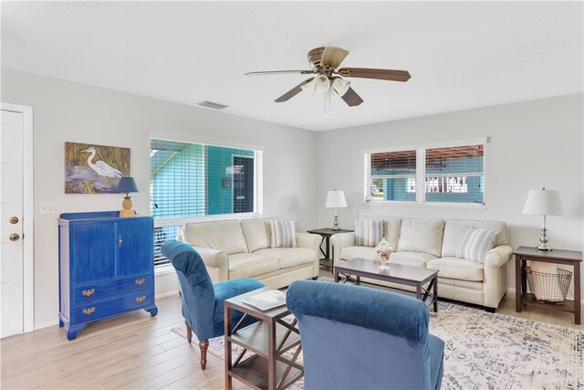 living room featuring light hardwood / wood-style floors and ceiling fan