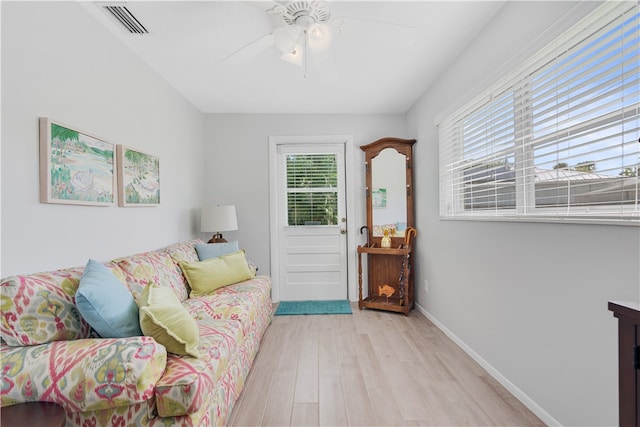 living room featuring light wood-type flooring and ceiling fan