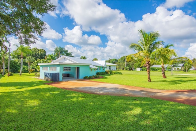 back of property featuring a lawn and a carport