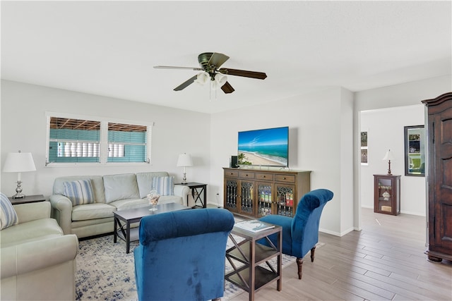 living room featuring ceiling fan and light hardwood / wood-style flooring