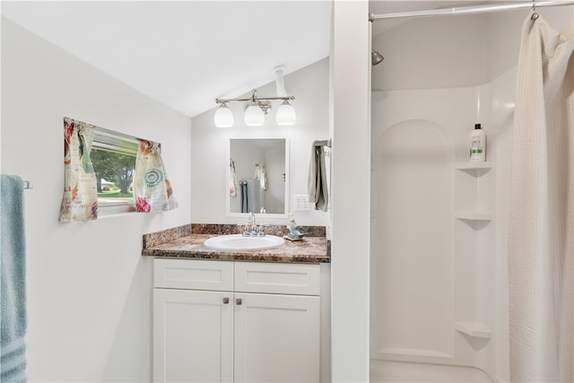 bathroom with vanity, vaulted ceiling, and a shower with shower curtain