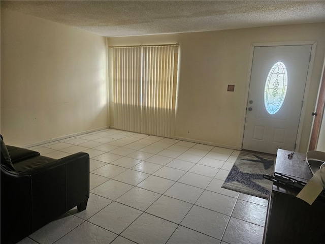 tiled entrance foyer featuring a textured ceiling