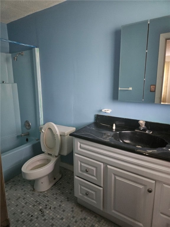 full bathroom featuring tile patterned floors, toilet, a textured ceiling, vanity, and bathtub / shower combination