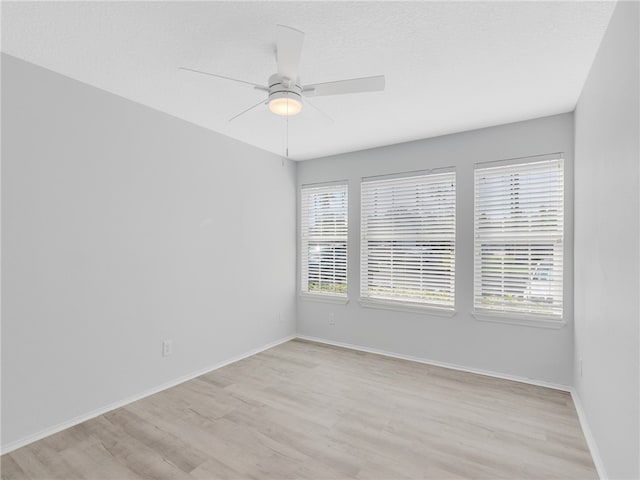 unfurnished room featuring ceiling fan and light hardwood / wood-style flooring