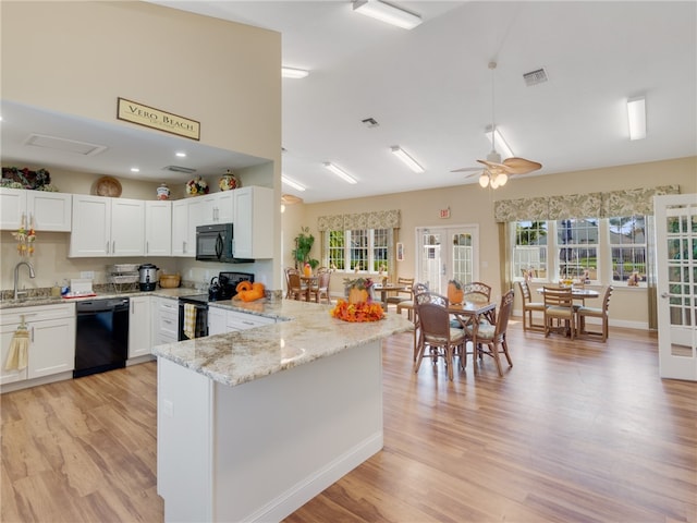 kitchen with sink, white cabinets, black appliances, and kitchen peninsula