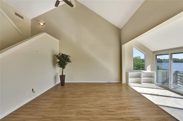 bonus room featuring lofted ceiling, a water view, ceiling fan, and hardwood / wood-style floors