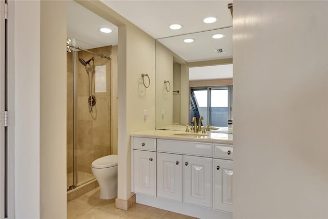 bathroom with toilet, vanity, walk in shower, and tile patterned flooring