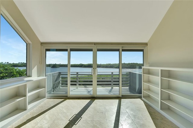 unfurnished sunroom with a wealth of natural light and a water view