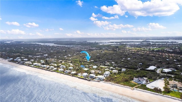 drone / aerial view featuring a beach view and a water view