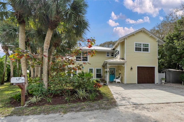 view of front of house featuring an attached garage, concrete driveway, and metal roof