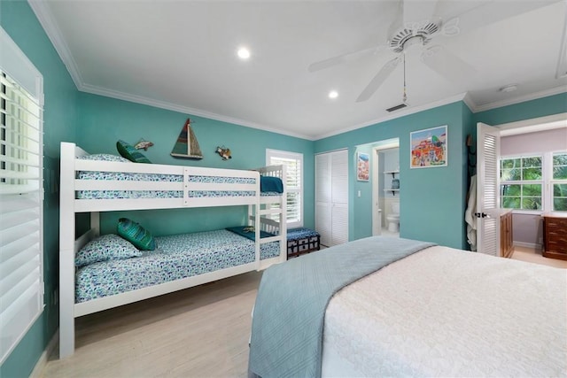 bedroom with crown molding, multiple windows, and hardwood / wood-style floors