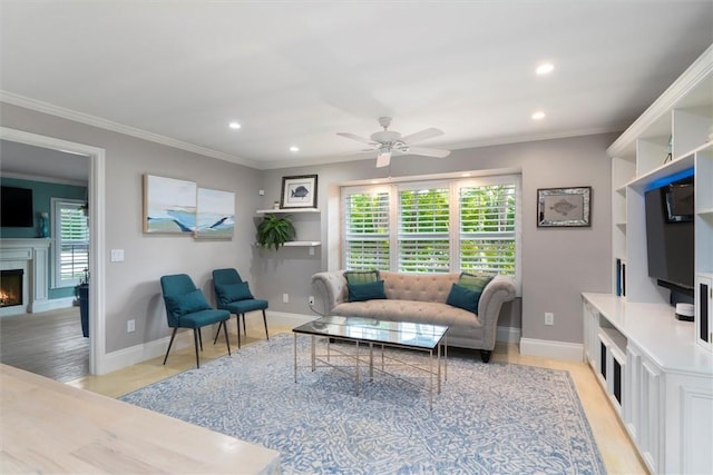 living room with ceiling fan, crown molding, and light hardwood / wood-style flooring