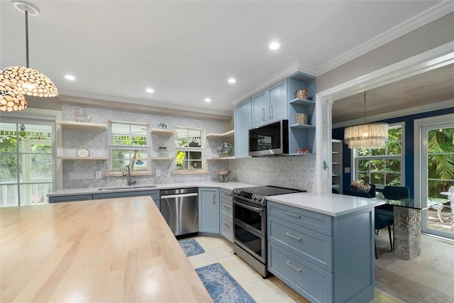 kitchen featuring open shelves, appliances with stainless steel finishes, wood counters, a chandelier, and ornamental molding