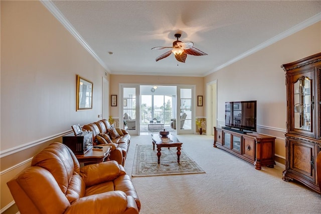 living room with light carpet, a textured ceiling, ceiling fan, and crown molding