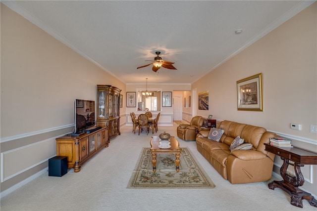 living room with ceiling fan with notable chandelier, carpet flooring, and ornamental molding