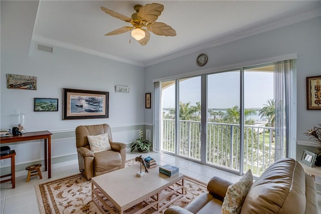 tiled living room with ceiling fan and crown molding