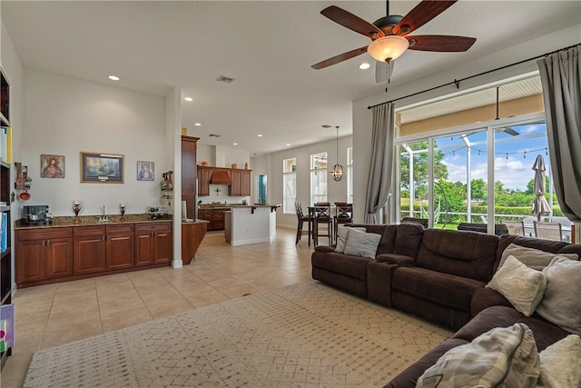 living room featuring light tile patterned floors and ceiling fan