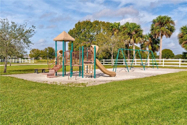 view of jungle gym featuring a lawn