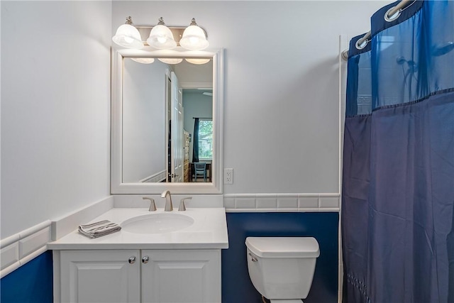 bathroom with vanity, toilet, and a shower with shower curtain