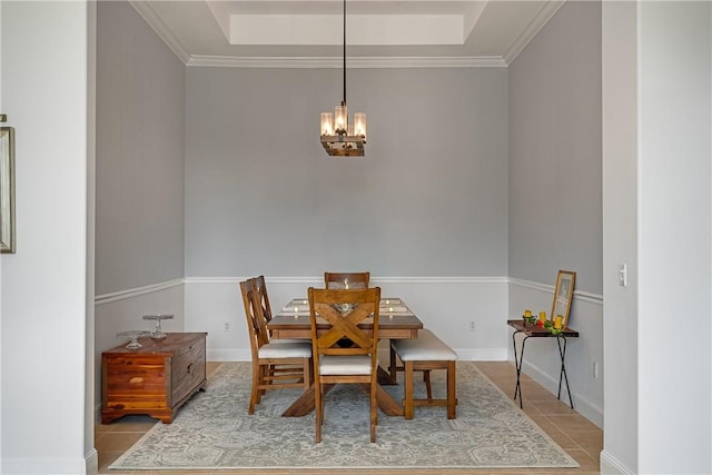 tiled dining room featuring crown molding and an inviting chandelier