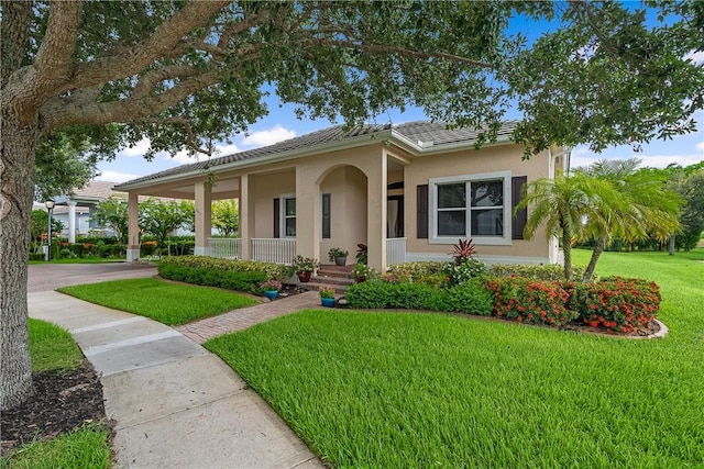 ranch-style home featuring a front yard and covered porch