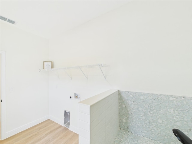 clothes washing area featuring visible vents, laundry area, hookup for a washing machine, and wood finished floors