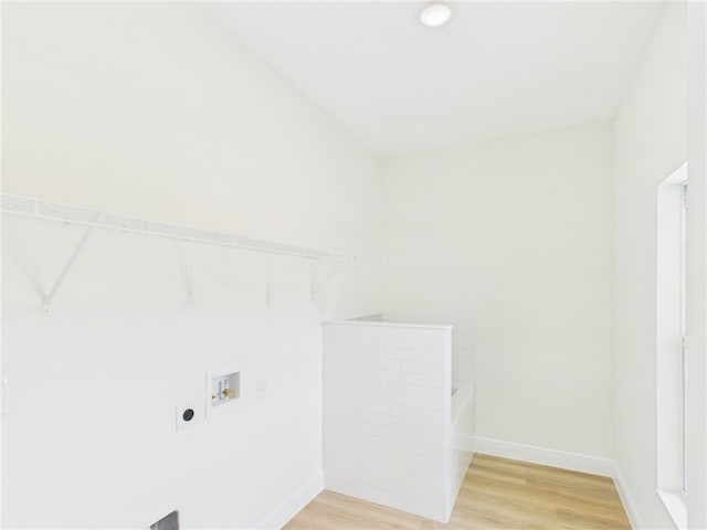 washroom with laundry area, hookup for a washing machine, electric dryer hookup, light wood-type flooring, and baseboards