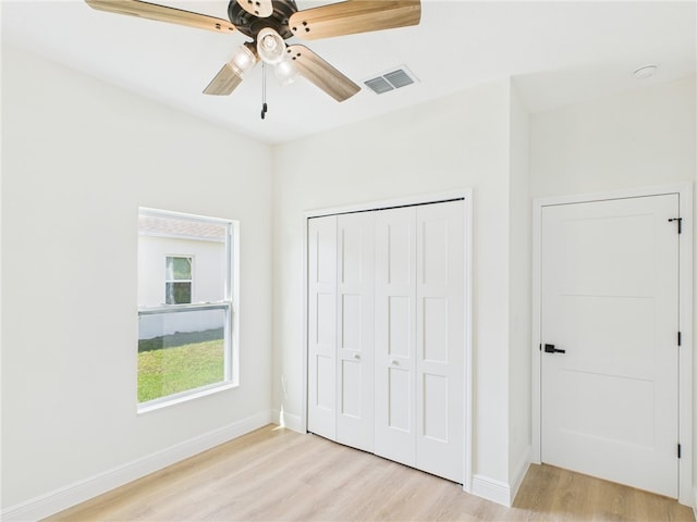 unfurnished bedroom featuring visible vents, light wood-type flooring, and baseboards