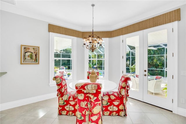 dining area with an inviting chandelier, baseboards, visible vents, and french doors