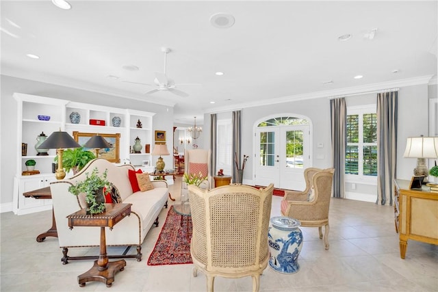 living room featuring ceiling fan with notable chandelier, french doors, ornamental molding, and recessed lighting