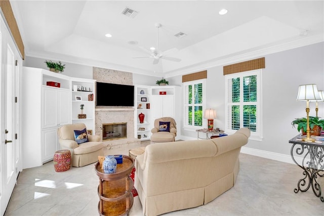 living room featuring recessed lighting, visible vents, baseboards, a high end fireplace, and a raised ceiling