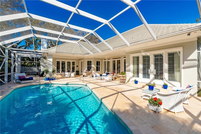 back of property featuring a tiled roof, french doors, and a patio area