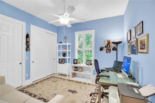 office space featuring a ceiling fan and baseboards