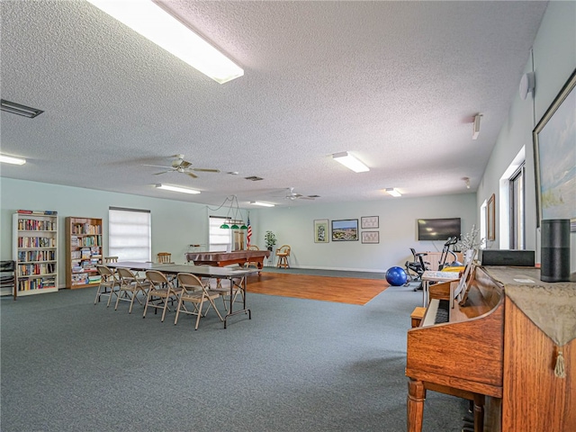 dining room with hardwood / wood-style floors, billiards, a textured ceiling, and ceiling fan