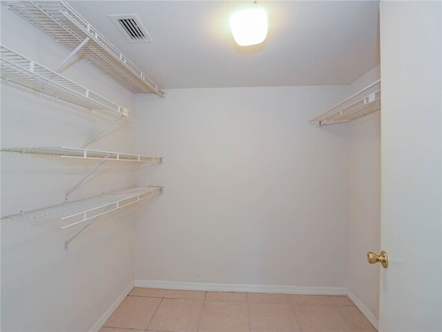 walk in closet with tile patterned flooring