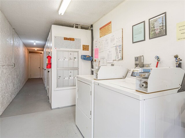 laundry area with a mail area, separate washer and dryer, and a textured ceiling