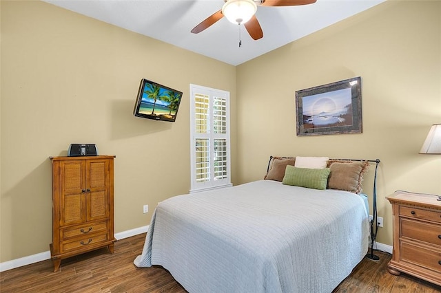 bedroom featuring dark wood-style flooring, ceiling fan, and baseboards