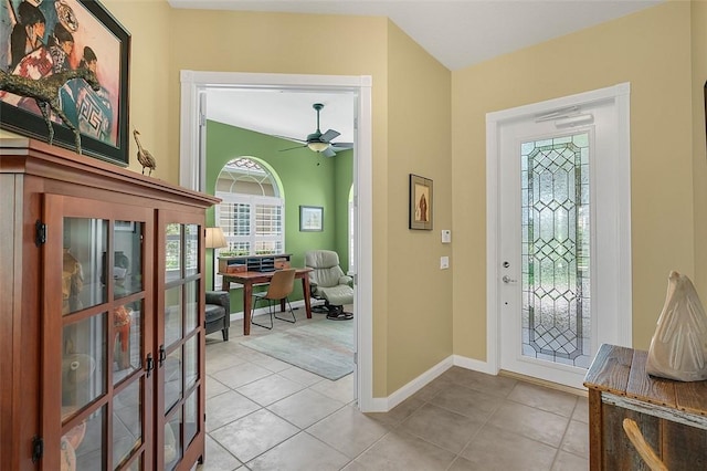 foyer entrance featuring baseboards, light tile patterned floors, a ceiling fan, and french doors