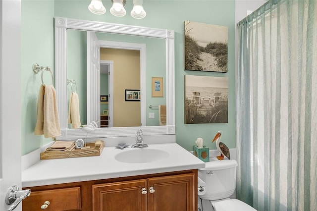 full bath featuring toilet, vanity, and a shower with shower curtain
