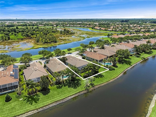 drone / aerial view with a residential view and a water view