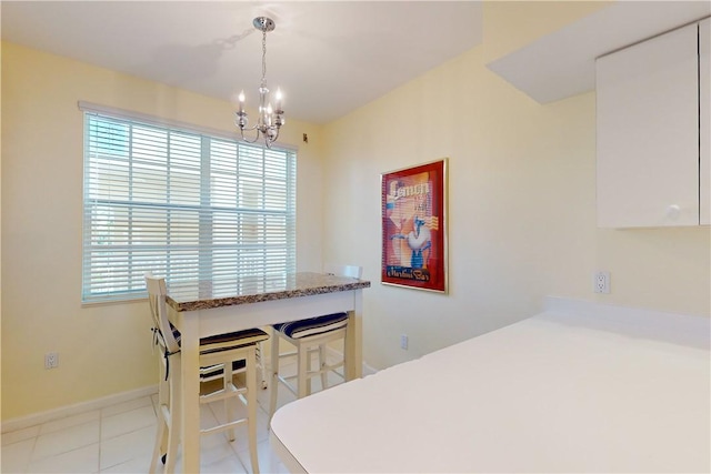 dining space featuring a chandelier and light tile patterned flooring