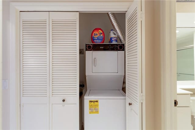 washroom with stacked washer / drying machine