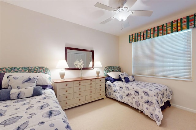 bedroom with light carpet and ceiling fan