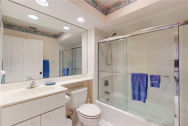 full bathroom with tile patterned flooring, vanity, toilet, and bath / shower combo with glass door