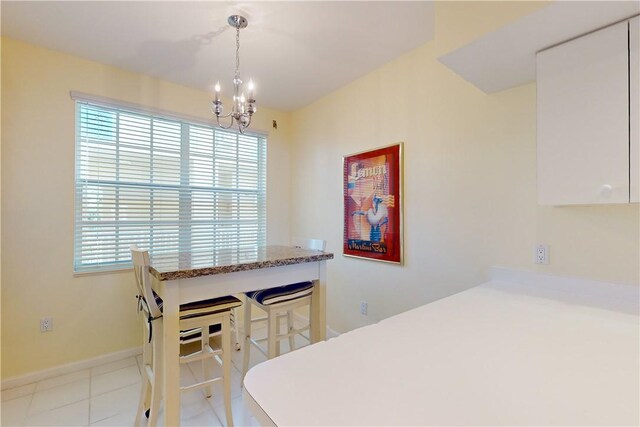 5540 N Harbor Village Dr Unit 204, Vero Beach, FL 32967 - tiled dining area featuring healthy amount of natural light and a chandelier