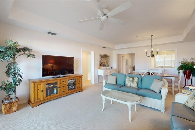 5540 N Harbor Village Dr Unit 204, Vero Beach, FL 32967 - living area featuring a tray ceiling, a chandelier, light carpet, and ceiling fan