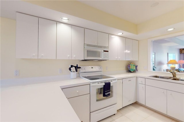 kitchen featuring white cabinetry, white appliances, and sink