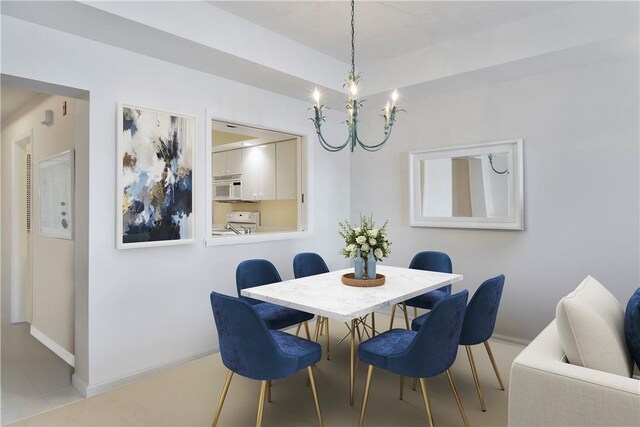 5540 N Harbor Village Dr Unit 204, Vero Beach, FL 32967 - dining room featuring a chandelier and baseboards